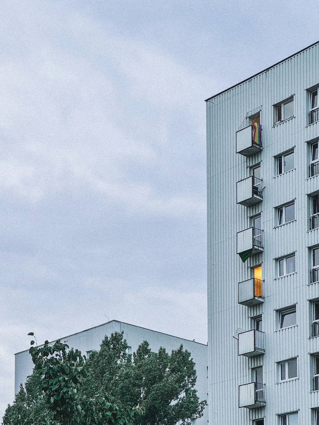 A white apartment block with balconies